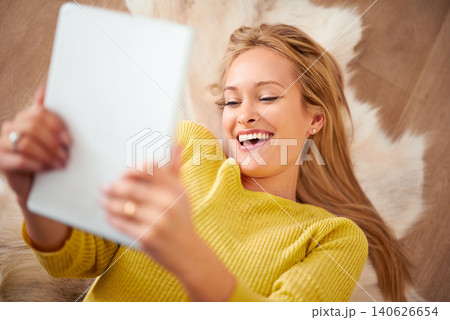 Face, tablet and smile with woman on floor of home for weekend browsing or communication from above. Technology, relax and happy with young person laughing in living room of apartment for download Face, tablet and smile with woman on floor of home for weekend browsing or communication from above. Technology, relax and happy with young person laughing in living room of apartment for download 140626654