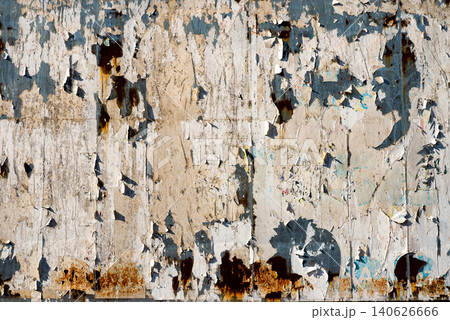 Abstract macro background of aged rusty wall with torn paper and peeling paint layers Abstract macro background of aged rusty wall with torn paper and peeling paint layers 140626666