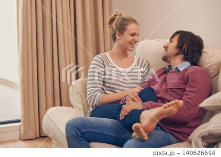Love, relax and couple on a sofa for bonding, chilling or flirting fun on weekend at home together. Happy, comfort and people in a living room with trust, support and care, security or conversation Love, relax and couple on a sofa for bonding, chilling or flirting fun on weekend at home together. Happy, comfort and people in a living room with trust, support and care, security or conversation 140626698