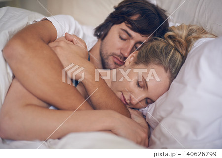Sleeping, peace and couple relax in a bed with care, support and safety, security and bonding in their home. Love, sleep and tired people embrace in a bedroom with comfort, nap or resting in a house Sleeping, peace and couple relax in a bed with care, support and safety, security and bonding in their home. Love, sleep and tired people embrace in a bedroom with comfort, nap or resting in a house 140626799