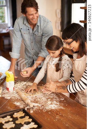 Parents, kid and happy with bake biscuits in kitchen for easter season or bonding, child development and growth. Home, family and flower or dough for cookies with fun, teaching and support on holiday Parents, kid and happy with bake biscuits in kitchen for easter season or bonding, child development and growth. Home, family and flower or dough for cookies with fun, teaching and support on holiday 140627215