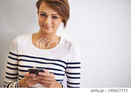 Girl, studio or portrait with smartphone, typing and face for social media or communication. Woman, phone and smile with technology, online connection or internet message isolated on white background Girl, studio or portrait with smartphone, typing and face for social media or communication. Woman, phone and smile with technology, online connection or internet message isolated on white background 140627773