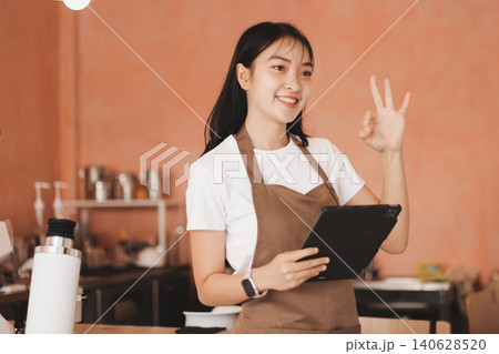 Young woman at barista school learning how to make espresso coffee. 140628520