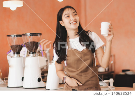 Young woman at barista school learning how to make espresso coffee. Young woman at barista school learning how to make espresso coffee. 140628524