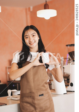 Young woman at barista school learning how to make espresso coffee. Young woman at barista school learning how to make espresso coffee. 140628525