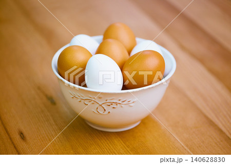 Agriculture, food and eggs in bowl for sustainability, organic produce and reproduction with wellness. Diet, closeup and protein from livestock for nutrition, breakfast or healthy meal on table 140628830