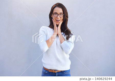 Happy woman, portrait and surprise with glasses in fashion for good news on a gray studio background. Face of female person, brunette or model with shock for winning, promo or bonus on mockup space Happy woman, portrait and surprise with glasses in fashion for good news on a gray studio background. Face of female person, brunette or model with shock for winning, promo or bonus on mockup space 140629244