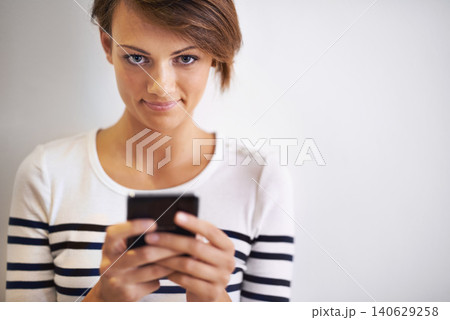 Teen, studio or portrait with smartphone, texting and face for social media or communication. Girl, phone and smile with technology, online connection or internet message isolated on white background Teen, studio or portrait with smartphone, texting and face for social media or communication. Girl, phone and smile with technology, online connection or internet message isolated on white background 140629258