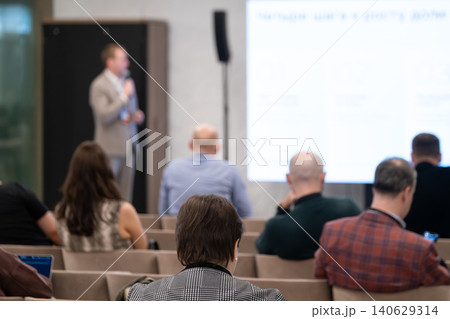 Business conference presentation with attendees listening in meeting room, professional seminar and corporate workshop Business conference presentation with attendees listening in meeting room, professional seminar and corporate workshop 140629314