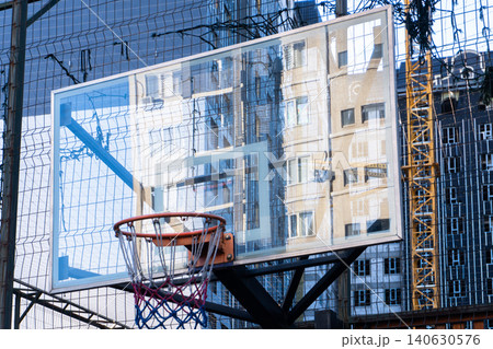 Basketball hoop with transparent backboard on urban outdoor court 140630576