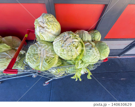 Cabbages in a shopping trolley on a footpath at a shopping centre carpark Cabbages in a shopping trolley on a footpath at a shopping centre carpark 140630629