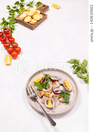 Herring fillet appetizer with red onion and lemon Herring fillet appetizer with red onion and lemon 140630662