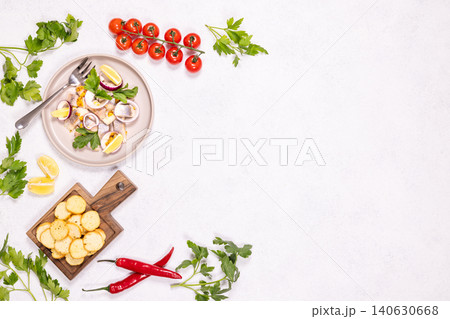 Marinated herring fillet rolls with red onion and lemon Marinated herring fillet rolls with red onion and lemon 140630668