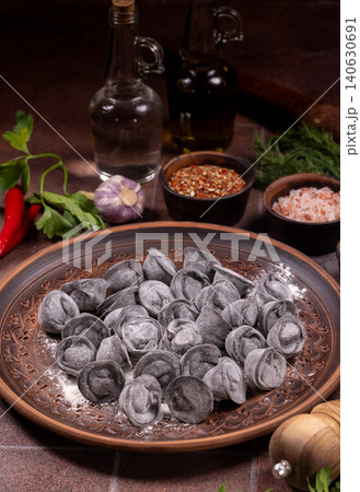 Black pelmeni dumplings with dough flour spices for cooking Black pelmeni dumplings with dough flour spices for cooking 140630691