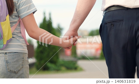 hold textbook hand, happy family, kid child carries school textbook hand, man father leads student backpack by hand, first-graders school backpacks walk with dad park, child with school backpacks 140631819