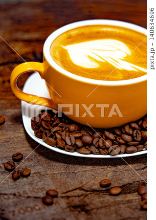 Cup of coffee decorated with a heart and coffee beans transparent dark background Cup of coffee decorated with a heart and coffee beans transparent dark background 140634696