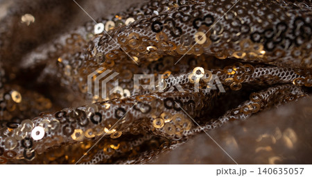 Horizontal fence shot with movements in gold sequined fabric. Abstract background Horizontal fence shot with movements in gold sequined fabric. Abstract background 140635057