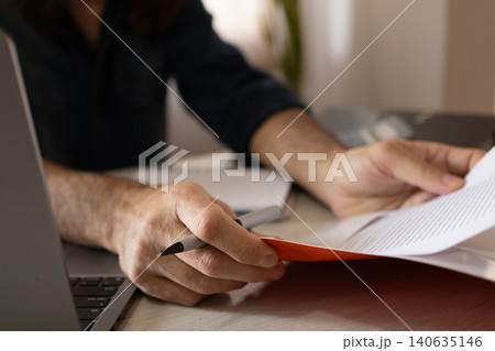 Close-up of a man's hands at his workspace. Insurance agent at work. Close-up of a man's hands at his workspace. Insurance agent at work. 140635146