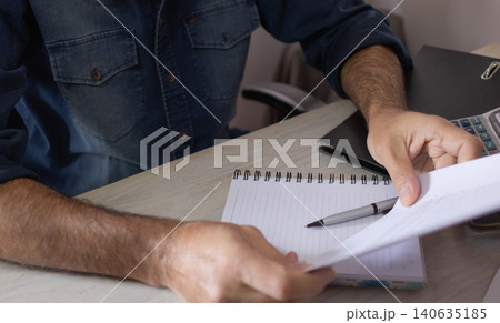 Businessman reading a contract.in his office. Business concept 140635185