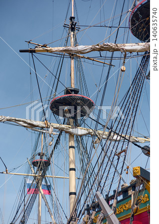 moored replica of an ancient sailing frigate in yacht club in Saint-Petersburg - Russia at clear sunny weather, huge masts, thick ropes moored replica of an ancient sailing frigate in yacht club in Saint-Petersburg - Russia at clear sunny weather, huge masts, thick ropes 140635740