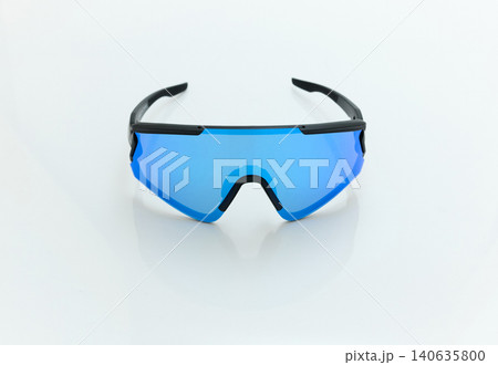 stylish sunglasses on a glossy white table, blue glass, black sunglasses frame, yachting glasses, cycling glasses, reflection on a glossy surface stylish sunglasses on a glossy white table, blue glass, black sunglasses frame, yachting glasses, cycling glasses, reflection on a glossy surface 140635800