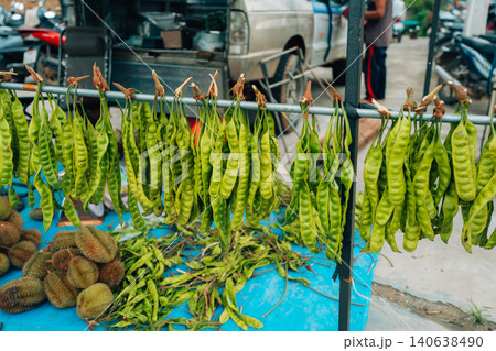 Bunches of fresh green stink beans (Sato) hanging for sale at a local Thai market 140638490