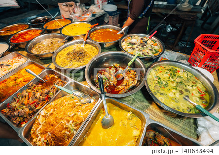 Variety of authentic Thai street food and Southern Thai curries at a local market stall Variety of authentic Thai street food and Southern Thai curries at a local market stall 140638494