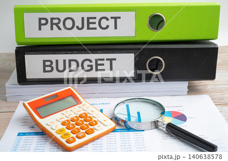 Project, Budget. binder with graph and calculator at office. 140638578