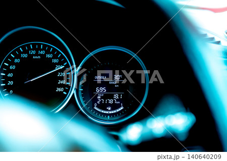 Closeup car fuel gauge dashboard panel. Gasoline indicator meter and speedometer. Fuel gauge show full gas tank. Data information dashboard show outside car temperature, trip range and fuel tank icon. Closeup car fuel gauge dashboard panel. Gasoline indicator meter and speedometer. Fuel gauge show full gas tank. Data information dashboard show outside car temperature, trip range and fuel tank icon. 140640209