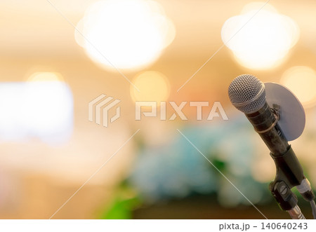 Microphone on stand at podium stage for public speaking or speech in conference hall. Mic for speaker on stage of event. Meeting and presentation in seminar room. Microphone for talking to audience. Microphone on stand at podium stage for public speaking or speech in conference hall. Mic for speaker on stage of event. Meeting and presentation in seminar room. Microphone for talking to audience. 140640243
