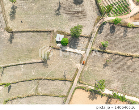 Harvested farmland with road, farm shelter and agricultural field. Traditional land use, seasonal crop production and countryside development. Rural landscape management and sustainable farming system Harvested farmland with road, farm shelter and agricultural field. Traditional land use, seasonal crop production and countryside development. Rural landscape management and sustainable farming system 140640516