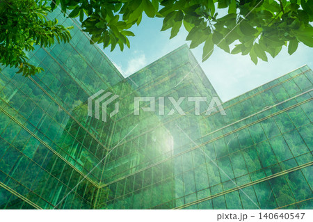 Eco-friendly building in the modern city. Sustainable glass office building with tree for reducing heat and carbon dioxide. Office building with green environment. Corporate building reduce CO2. 140640547