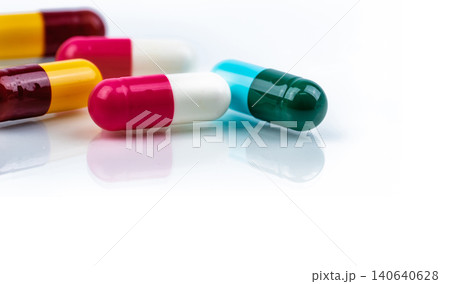 Colorful antibiotic capsule pills on white background. Pharmaceutics concept. Antibiotic drug resistance. Pharmaceutical industry. Pharmacy drugstore. Healthcare medication. Antimicrobial capsule. Colorful antibiotic capsule pills on white background. Pharmaceutics concept. Antibiotic drug resistance. Pharmaceutical industry. Pharmacy drugstore. Healthcare medication. Antimicrobial capsule. 140640628