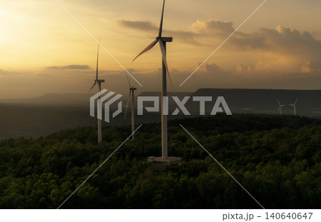 Wind energy. Wind power. Sustainable, renewable energy. Wind turbines generate electricity. Windmill farm on a mountain with sunset sky. Green technology. Renewable resource. Sustainable development. 140640647