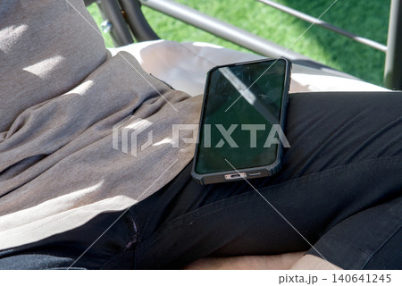 close up of man with smartphone and earphones 140641245