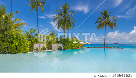 Palm-lined tropical beach with a wooden jetty and overwater villas under a vivid blue sky. Maldives luxury resort scene. Stunning summer travel background with turquoise water and white sand. Inspire Palm-lined tropical beach with a wooden jetty and overwater villas under a vivid blue sky. Maldives luxury resort scene. Stunning summer travel background with turquoise water and white sand. Inspire 140641625