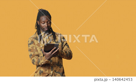 Modern person navigating online on tablet in studio, using mobile device to check social media apps and browse internet pages, with man checking websites on gadget. Modern person navigating online on tablet in studio, using mobile device to check social media apps and browse internet pages, with man checking websites on gadget. 140642453