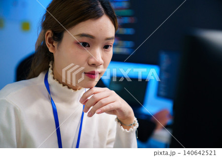 Focused software developer at workstation in modern tech office Focused software developer at workstation in modern tech office 140642521