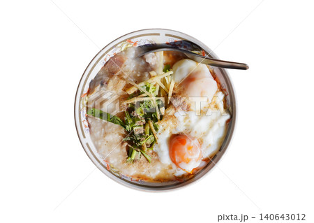 Homemade Asian rice porridge served with soft boiled eggs isolated. Homemade Asian rice porridge served with soft boiled eggs isolated. 140643012