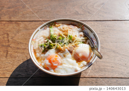 Homemade Asian rice porridge served with soft boiled eggs. Homemade Asian rice porridge served with soft boiled eggs. 140643013
