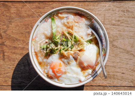Homemade Asian rice porridge served with soft boiled eggs. Homemade Asian rice porridge served with soft boiled eggs. 140643014