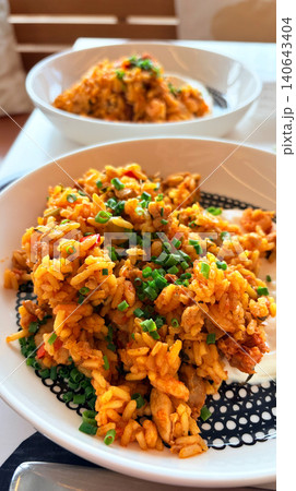 Spanish Style Fried Rice (Paella) with Chicken and Vegetables Served on White Plate Spanish Style Fried Rice (Paella) with Chicken and Vegetables Served on White Plate 140643404