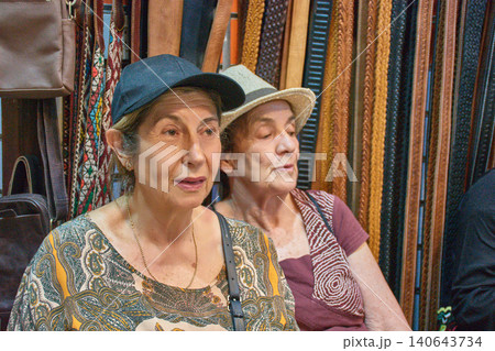 Two women smiling as they pose together during a sightseeing trip through the medina of Fez, Morocco Two women smiling as they pose together during a sightseeing trip through the medina of Fez, Morocco 140643734
