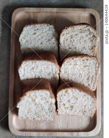 Freshly Sliced White Bread Loaf Pieces Arranged in Wooden Tray for Breakfast, Bakery Serving, or Homemade Meal Preparation Freshly Sliced White Bread Loaf Pieces Arranged in Wooden Tray for Breakfast, Bakery Serving, or Homemade Meal Preparation 140644439