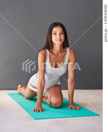 Yoga mat, calm and portrait of woman stretching in apartment for zen, wellness and fitness exercise. Balance, smile and young female person with pilates workout for body movement on floor at home. 140644600