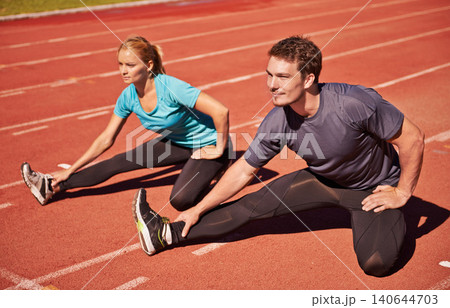 Workout, legs and couple stretching in stadium for race, marathon or competition training for health. Sports, energy and runner athletes with warm up exercise for running cardio on outdoor track. Workout, legs and couple stretching in stadium for race, marathon or competition training for health. Sports, energy and runner athletes with warm up exercise for running cardio on outdoor track. 140644703