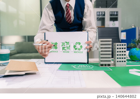 Businessman using computer on CO2 emission reduction concept. along with climate, energy, sustainability, environment. Businessman using computer on CO2 emission reduction concept. along with climate, energy, sustainability, environment. 140644802