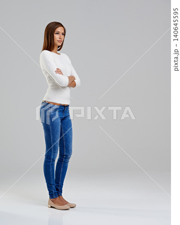 Thinking, arms crossed and woman in studio for fashion isolated on a white background mockup space. Confidence, dream and serious model in casual clothes, jeans or vision for trendy style on backdrop Thinking, arms crossed and woman in studio for fashion isolated on a white background mockup space. Confidence, dream and serious model in casual clothes, jeans or vision for trendy style on backdrop 140645595