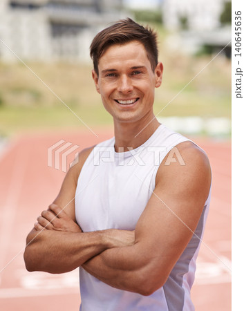 Athlete, portrait and happy for fitness on stadium, commitment and wellness of sprinting professional. American, man and face with smile for confident in sport, outdoor and training for health body 140645636