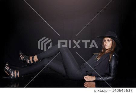 Portrait, classic fashion and young woman in studio on black background for chic or classy style. Leather, model and space with confident fashionista person in dark or trendy clothes outfit and hat 140645637